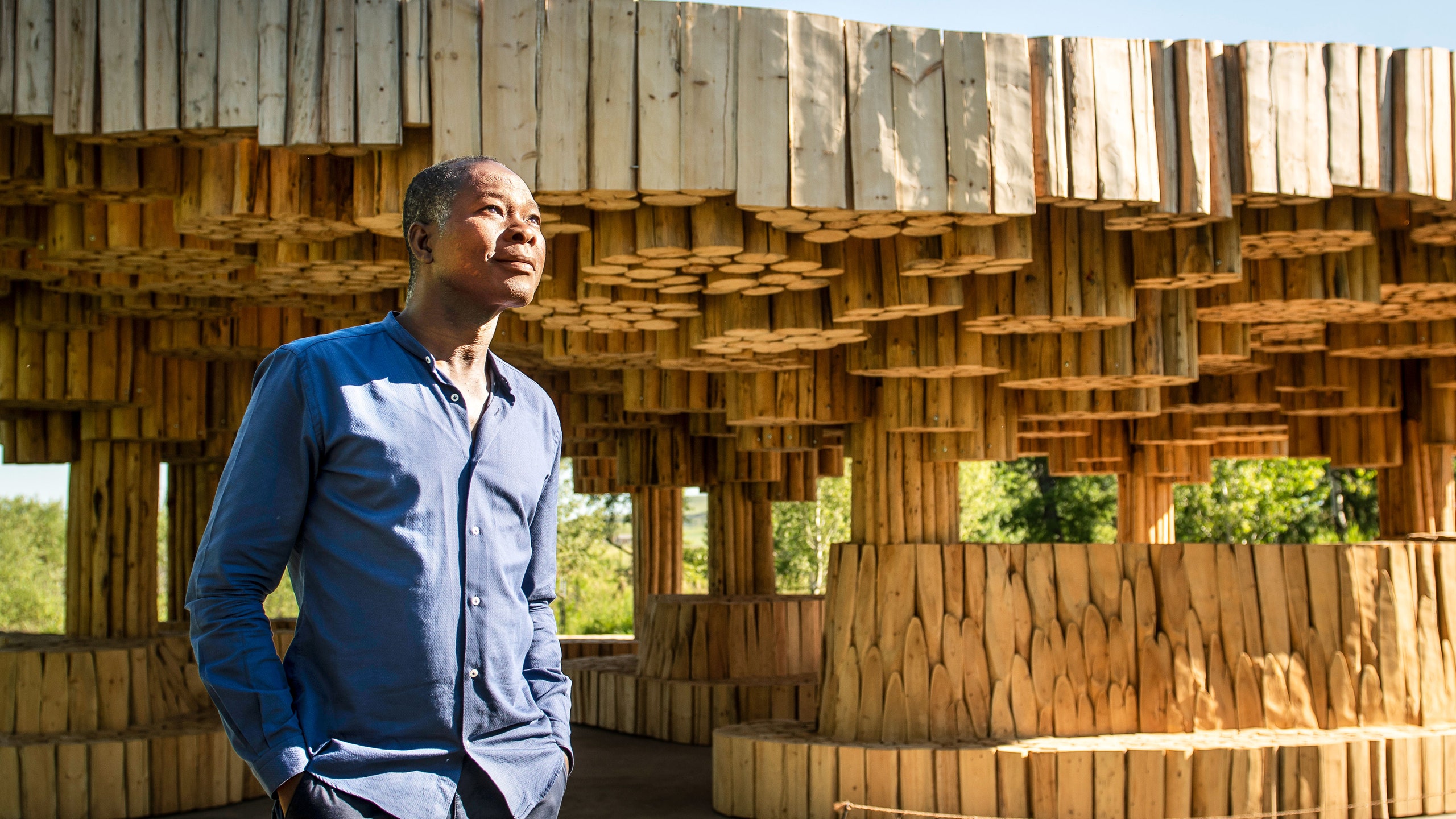 Francis Kéré outside of the Xylem pavilion in Montana. Photo credit: Erik Petersen.