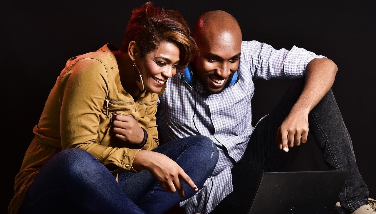 Couple watching videos on a laptop.