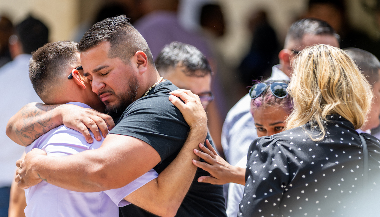 People grieve outside of the funeral of one of the 19 children killed in the Uvalde massacre. Photo: Brandon Bell/Getty Images.