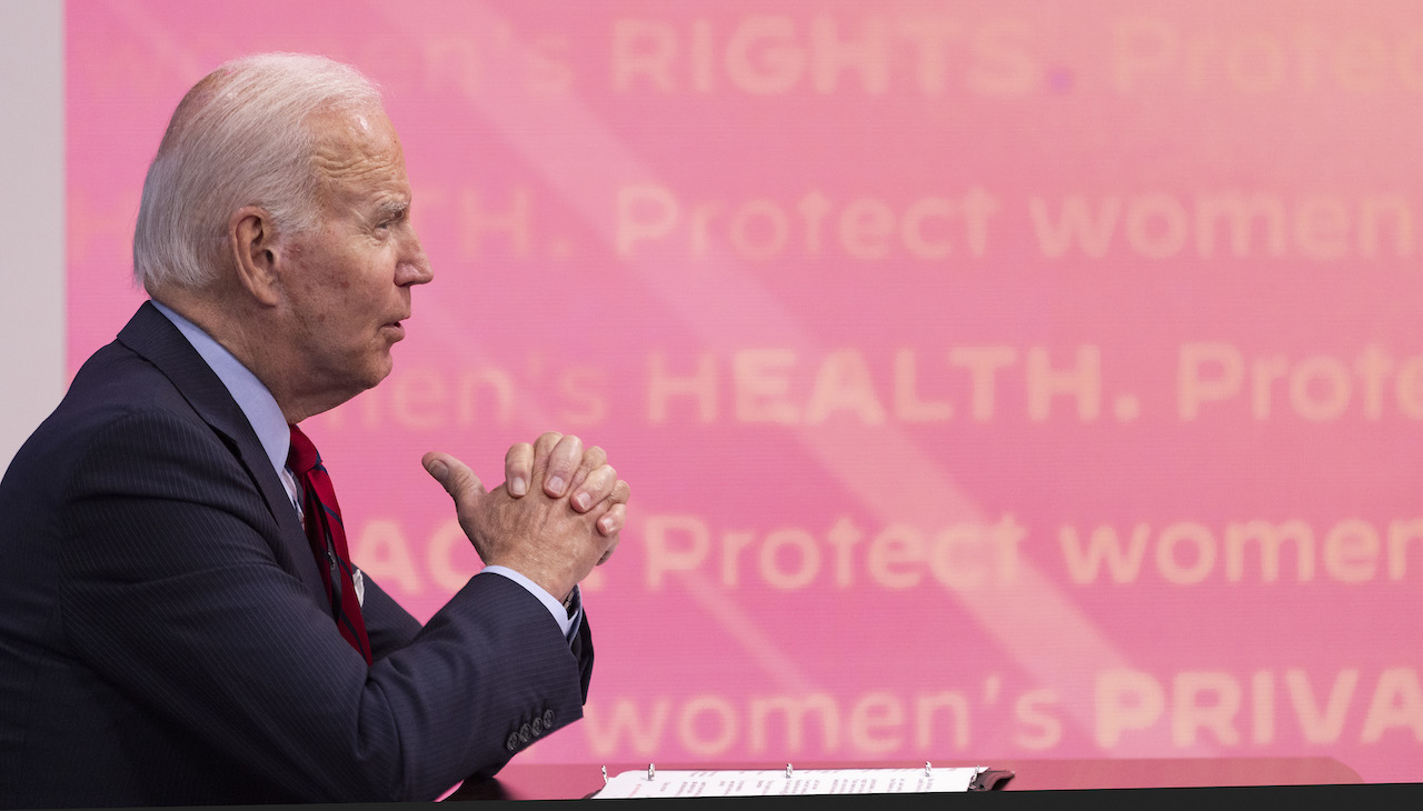 Pictured: President Joe Biden against pink background that reads "Protect women"