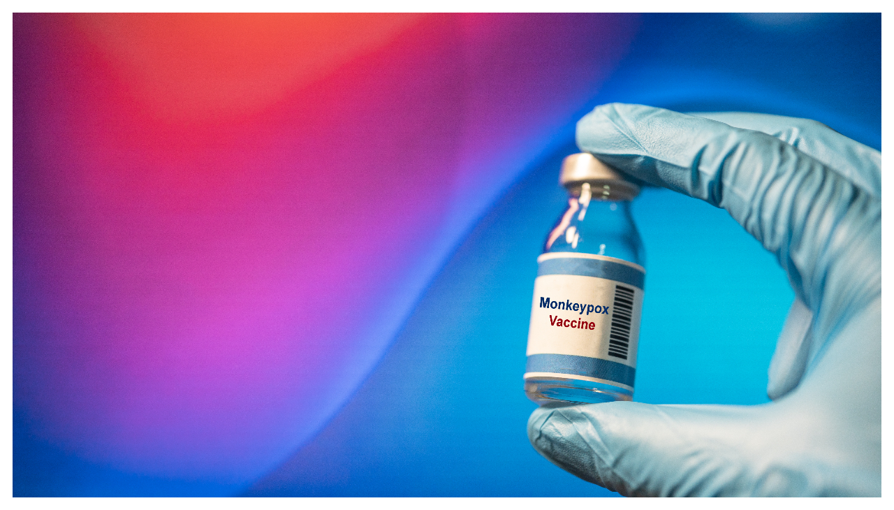 A vial of monkeypox vaccine being held in a gloved hand.