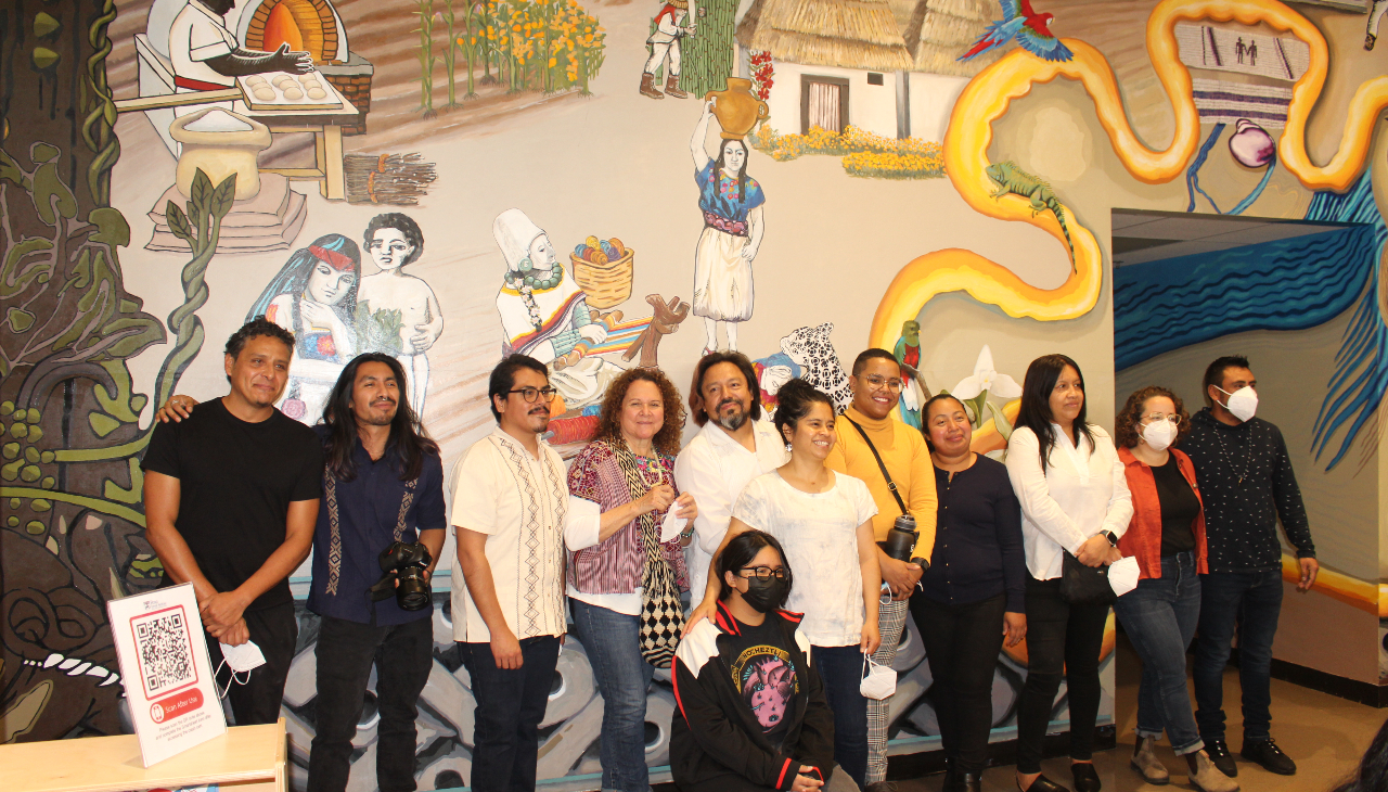 Muralists and members of Puentes de Salud staff pose in front of The Sky mural. Photo credit: Emily Leopard-Davis/AL DÍA News