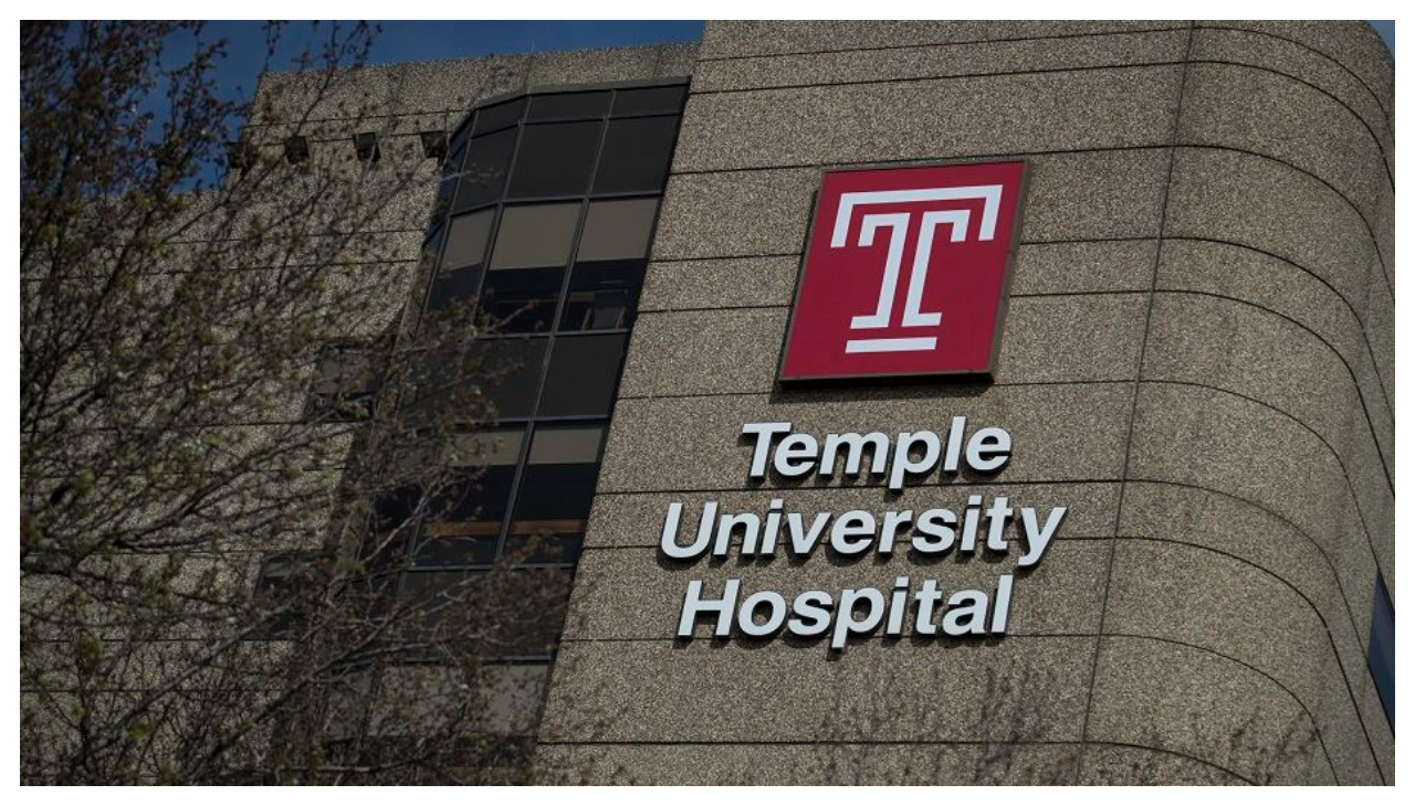 Lettering on the side of a building reading "Temple University Health" alongside the Temple Health logo.
