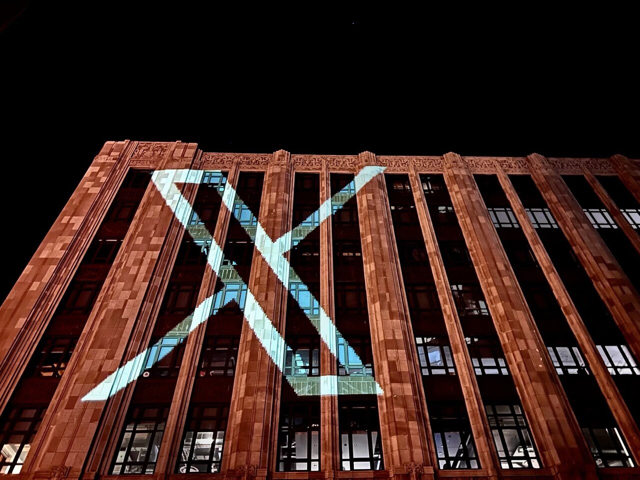 Twitter headquarters with the new logo displayed on the facade. 
