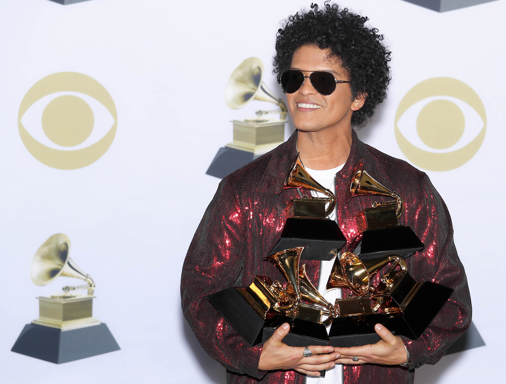 Bruno Mars poses with his six Grammys in the pressroom during the 60th annual Grammy Awards ceremony at Madison Square Garden in New York, New York, USA, 28 January 2018.