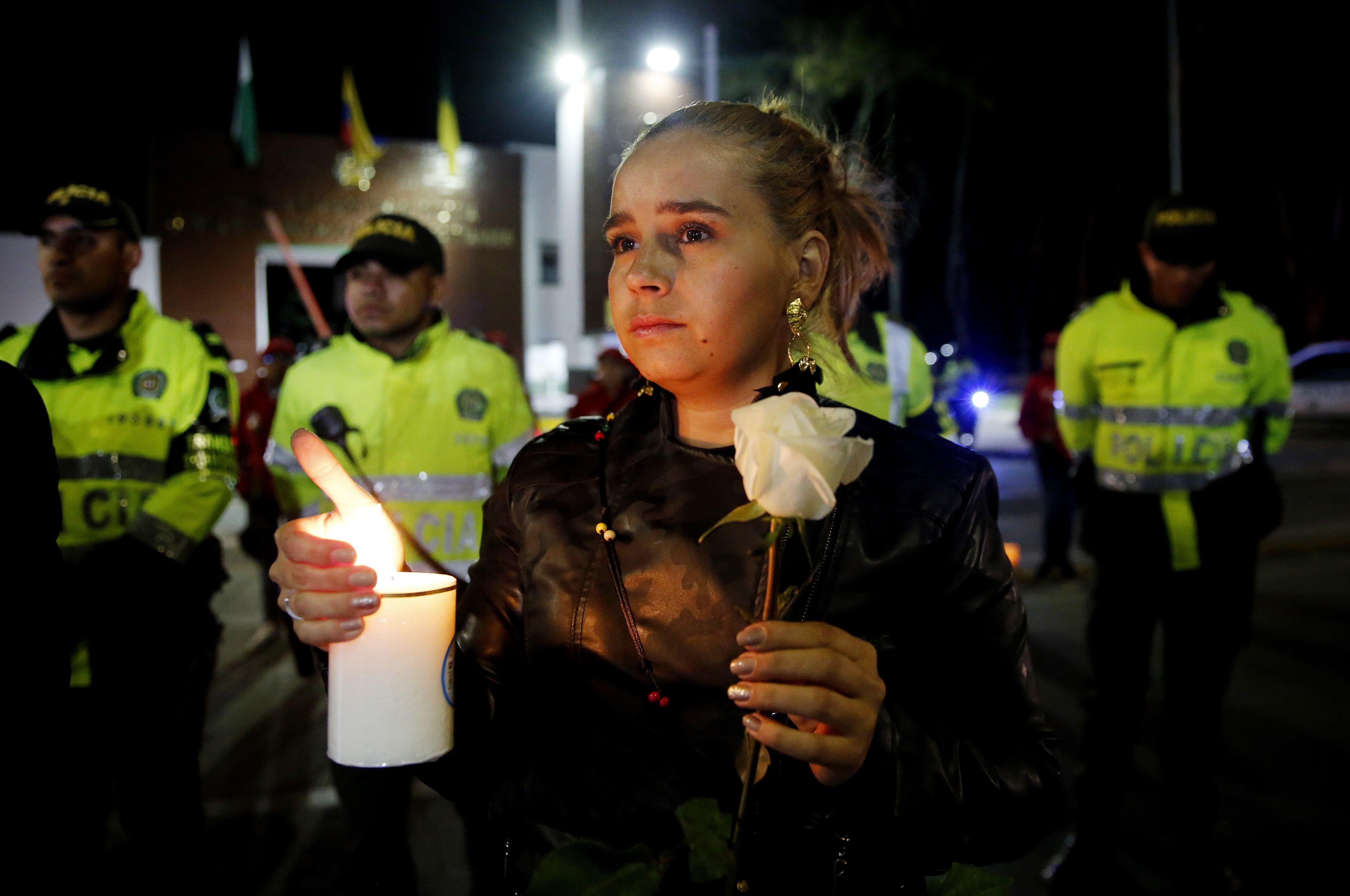 Citizens and police participate in a sit-in in front of the Francisco de Paula Santander police cadet academy in Bogota, Colombia, on Jan. 17, 2019, to honor the memory of those 20 cadets who died on Jan. 17, 2019, in a car-bomb attack. EPA-EFE/Leonardo Munoz