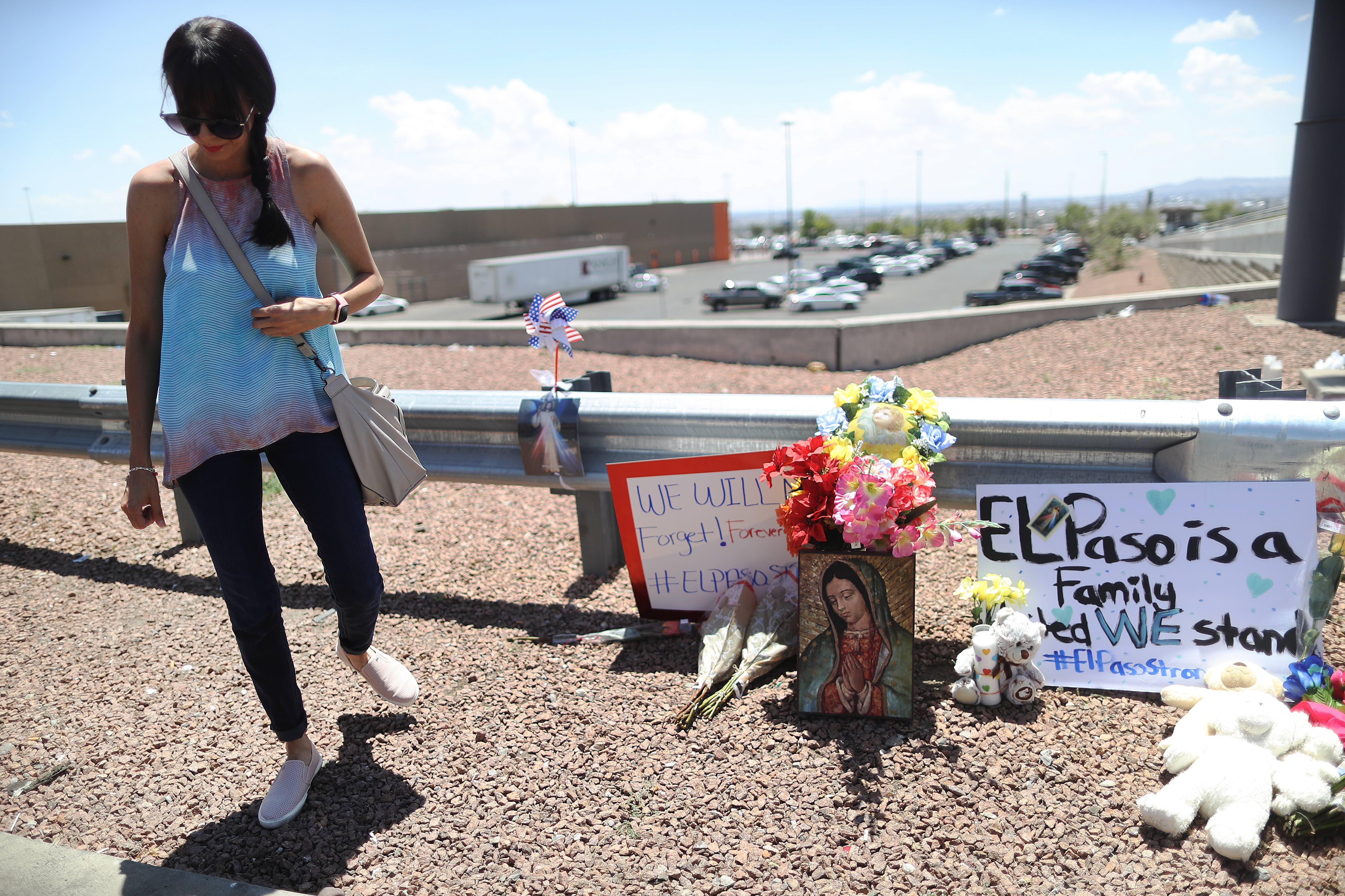 EL PASO, TEXAS - AUGUST 04: A woman walks away from a makeshift memorial outside Walmart, near the scene of a mass shooting which left at least 20 people dead, on August 4, 2019 in El Paso, Texas. Photo: Mario Tama/Getty Images