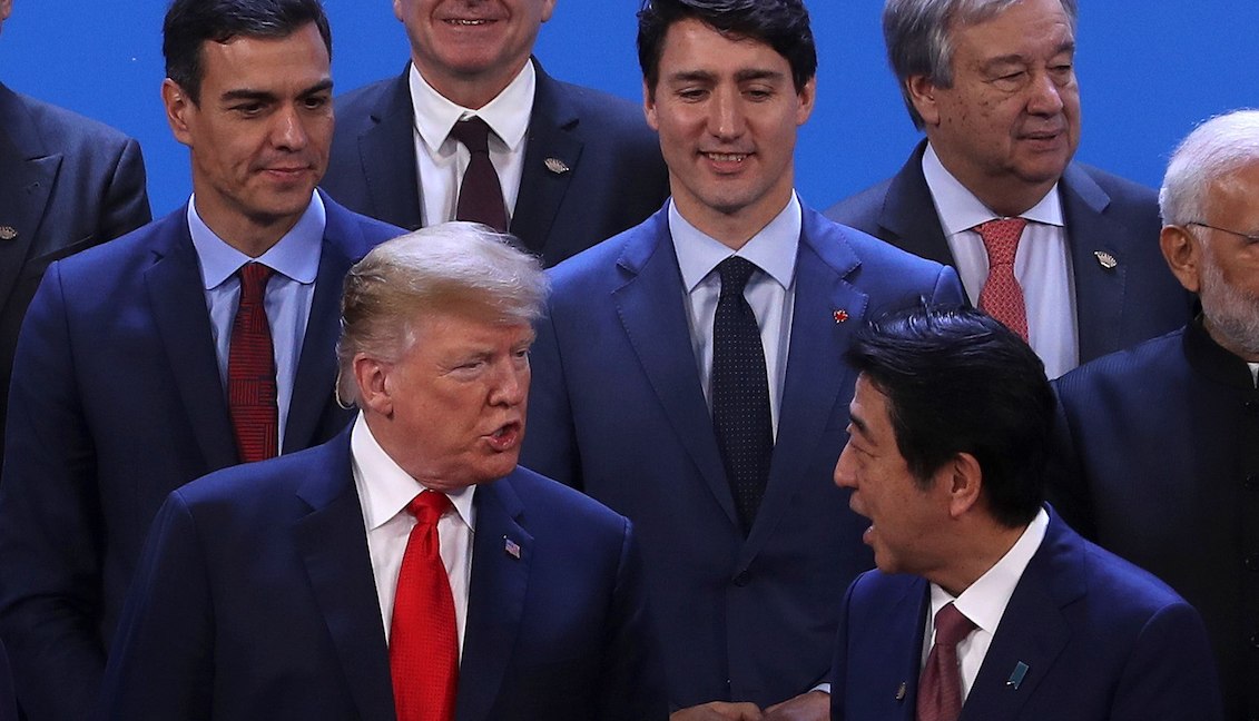 The US president, Donald Trump (first row-left), talks with the Prime Minister of Japan, Shinzo Abe (first row-right), in the presence of the Spanish Prime Minister, Pedro Sánchez (second row-left) and the Prime Minister from Canada, Justin Trudeau (second row-right), during the family photography of the G20 Summit held at the Costa Salguero convention center in Buenos Aires (Argentina). EFE/Ballesteros